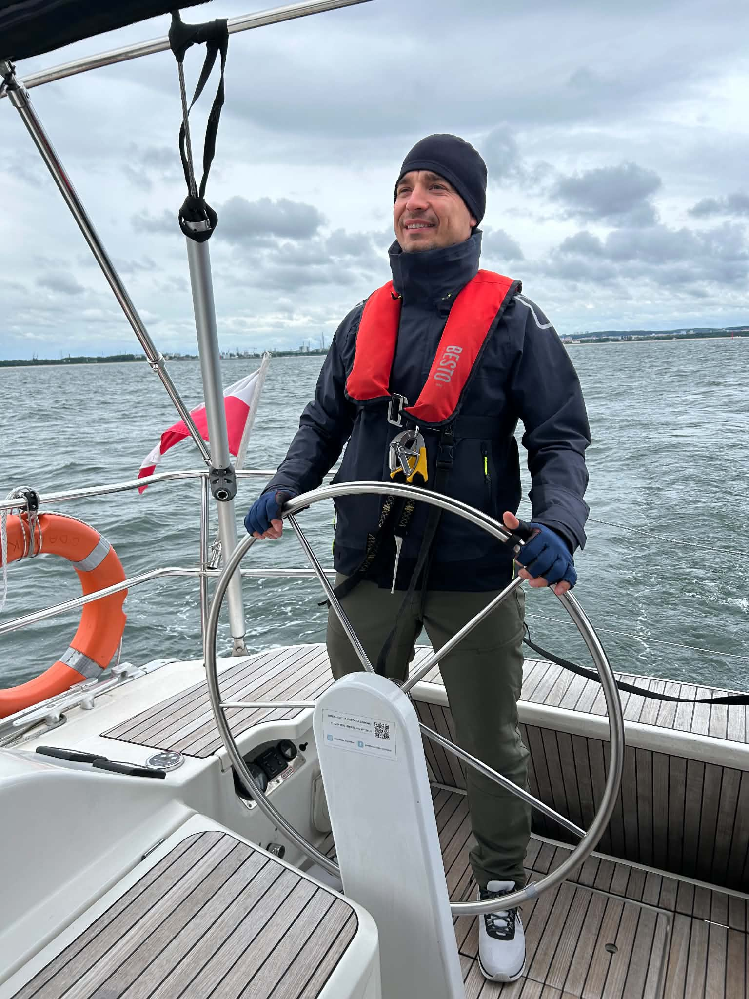 Marcin Wadas at the helm of a sailing yacht